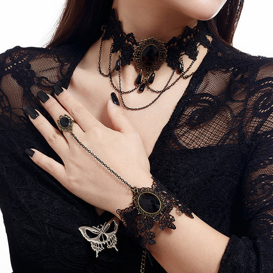 Modelo luciendo la pulsera de encaje negro con gema central y anillo ajustable.